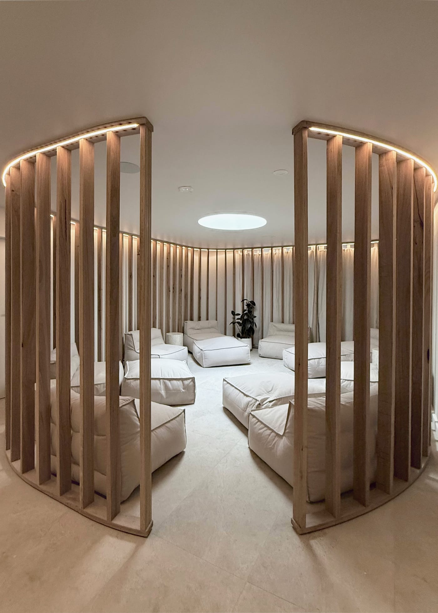 The round upstairs lounge seen through the timber slats, with its round skylight
