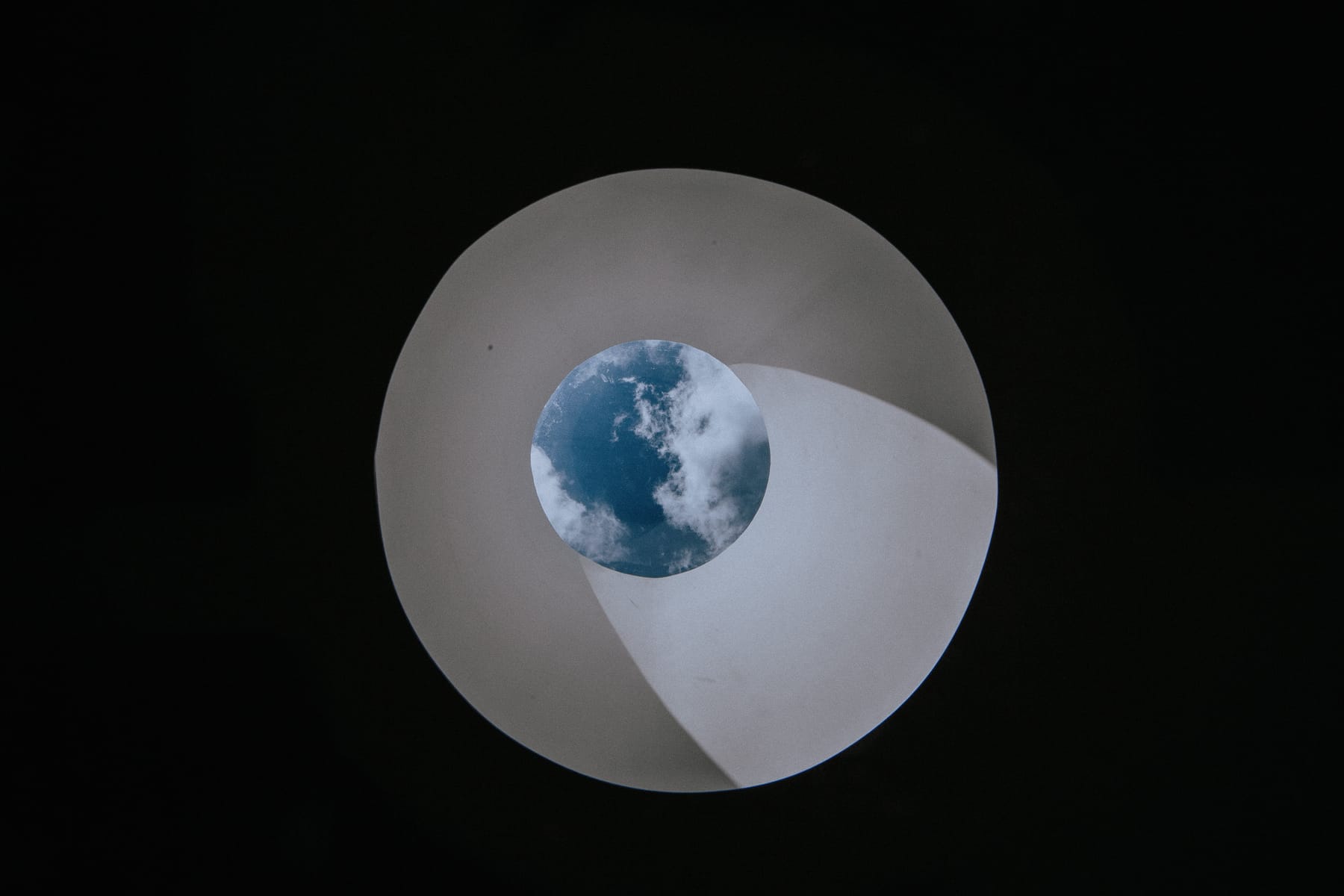 Looking straight up the round skylight to the sky